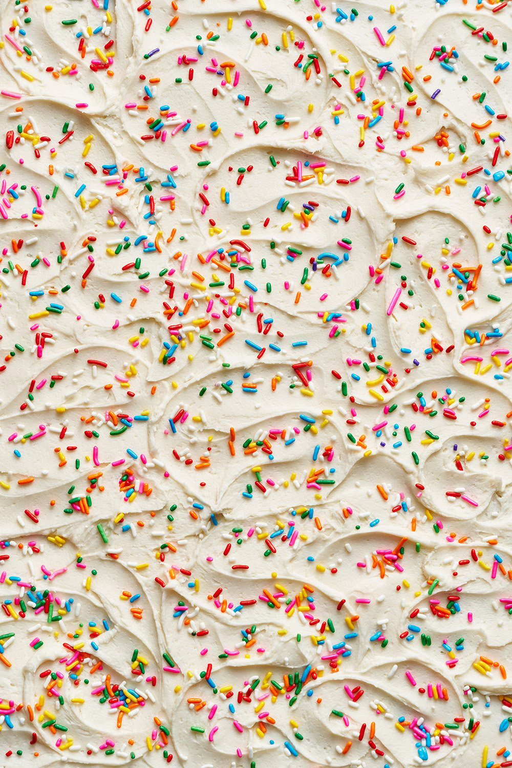 cream cheese frosting swirls with sprinkles.