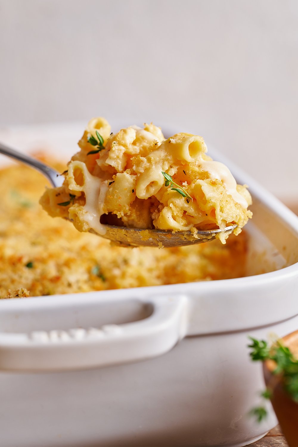 closeup of a spoon of mac and cheese, ready to serve onto a plate.