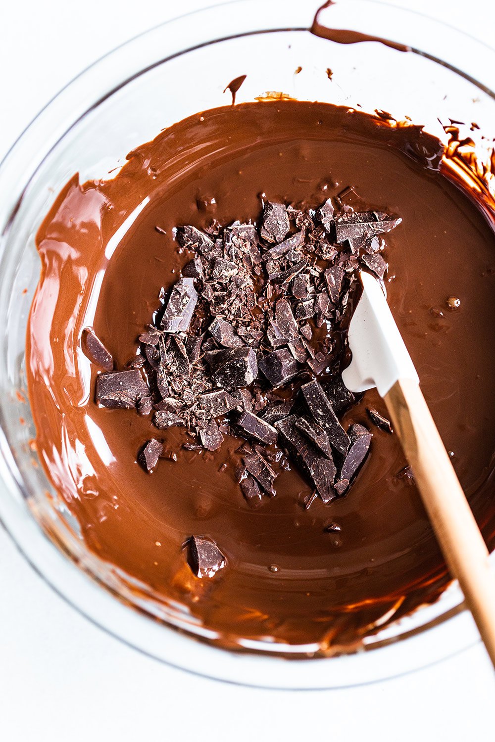 showing the seeding method of tempering chocolate, in a glass bowl